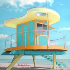 a lifeguard tower sitting on top of a sandy beach