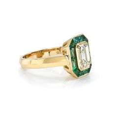 2.00ct M/VVS1 GIA certified emerald cut diamond with 1.05ctw French cut green emeralds bezel set in a handcrafted 18K yellow gold mounting. French Cut, Emerald Cut Diamond, Single Stone, Band Bracelet, Stone Collection, Antique Diamond, Fine Jewelry Collection, Emerald Cut Diamonds, Chain Ring