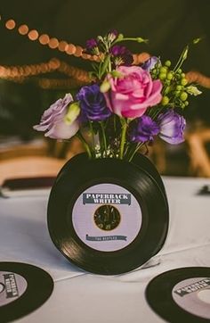 there is a vase with flowers in it on top of the table at this wedding reception