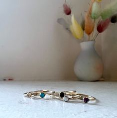 These dainty rings come in a variety of stones and sizes. Choose from opal, moonstone, turquoise, onyx, or faceted rose cut amethyst. Perfect for stacking together, with other rings, or alone! The stones are 3mm. Minimalist Natural Stone Rings For Everyday, Adjustable Opal Stackable Rings, Minimalist Rings With Natural Stones, Minimalist Stackable Turquoise Ring, Minimalist Turquoise Gemstone Stackable Rings, Minimalist Turquoise Promise Ring With Birthstone, Minimalist Turquoise Promise Ring, Minimalist Turquoise Birthstone Ring, Dainty Stackable Turquoise Ring