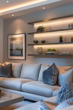 a living room filled with white furniture and lots of shelves above the sectional couches