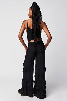 Make a statement for the frill of it in these need-now novelty pants. **Fit:** Mid-rise, billowy tiered design **Features:** Pull-on design, tiered ruffle trimming, raw-edge details, back smocked waistband feature **Why We | Rock And Frill Pants by Free People in Black, Size: S Black Ruffled Pants For Summer, Summer Black Ruffled Pants, Black Ruffled Pants For Spring, Black Wide Leg Bottoms With Ruffles, Chic Wide Leg Ruffled Pants, Bohemian Tiered Bottoms With Ruffles, Black Bottoms With Layered Hem For Summer, Chic Tiered Bottoms With Ruffle Hem, Chic Black Ruffled Pants