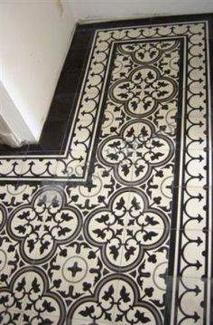 a bathroom floor with black and white tile