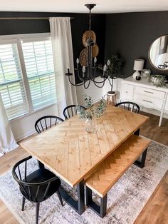 a dining room table with chairs and a chandelier