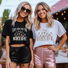 two beautiful young women standing next to each other wearing matching shirts and sequin shorts