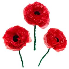 three red paper flowers on a white background