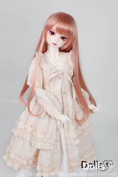 a doll with long pink hair is wearing a white dress and holding her hands in her pockets