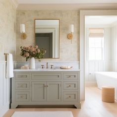 a bathroom with two sinks and a large mirror on the wall next to a bathtub