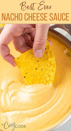 A hand dipping a tortilla chip into a skillet of Nacho Cheese sauce. Nachos With Nacho Cheese Sauce, Cheese Sauce With Velveeta Recipe, Best Nacho Dip Recipes, Cheese Sauce For Nachos Without Velveeta, Fiesta Nacho Cheese Soup Dip, Nacho Cheese Sauce Velveeta Rotel, Quick Nacho Cheese Sauce, Nacho Cheese In Crockpot, Crockpot Nachos Cheese