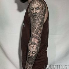 a man with a beard and tattoos on his arm