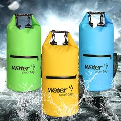 three waterproof bags are in the water and one is yellow, blue, and green