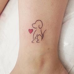 a small dog with a heart tattoo on the ankle