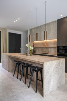 a kitchen with marble counter tops and stools