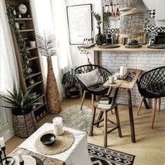 a living room filled with lots of furniture and decor on top of a hard wood floor