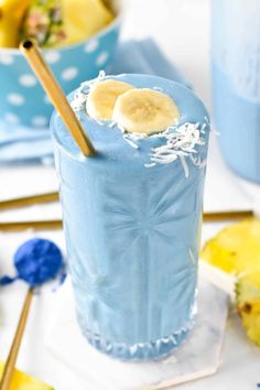 there is a blue drink with bananas and coconut in it