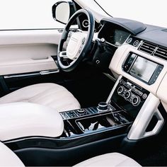 the interior of a car with white leather and black trim