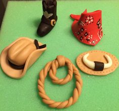 some toys are laying out on a green table top with it's hats and other items