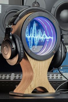 headphones are sitting on top of a wooden stand