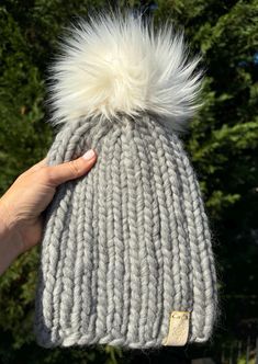 Women's knit hat in loppet pattern with cascade magnum merino wool. Hand wash and lay flat. Removable faux fur 6" Pom Pom.   Measurements approximately 8" wide, 9" tall. One size fits most. Materials: 100% merino wool, faux fur Pom Pom  Pattern by: Wooly Bear Knits  Choking hazard - keep button, tags and strings away from small children. Wooly Hat, Button Tags, Woolly Bear, Wooly Hats, Faux Fur Pom Pom, Skull Cap Beanie, Fur Pom Pom, Knitting Women, Skull Cap