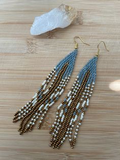 -Handmade seed bead earrings with light blue (Cinderella blue, in my opinion), gold, and cream colored seed beads. - All seed beads are Toho Seed Beads size 11/0 -Gold colored earring hooks - Approximately 4.5 inches in length Pearl Teardrop Earrings, Beaded Earrings Diy, Beaded Earrings Patterns, Beaded Dangle Earrings, Color Dorado, Fringe Earrings, Earring Patterns, Seed Bead Earrings, Beaded Dangles