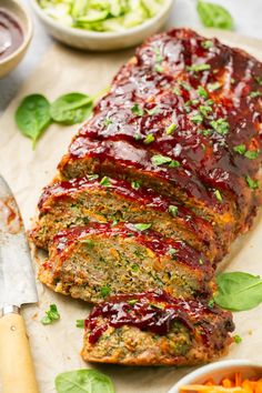 sliced meatloaf with sauce and vegetables on the side