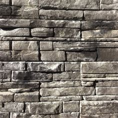 a stone wall that is made out of various types of rocks