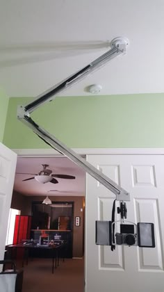 a ceiling fan is hanging from the ceiling in a room with green walls and white doors