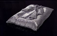 a silver sequined cloth on a black surface