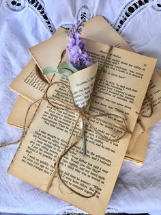 an old book is wrapped in twine and tied up with a flower on top