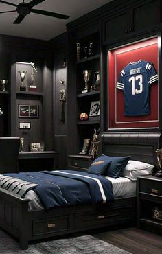 a bedroom with a bed, desk and soccer jersey on the wall