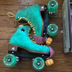 the skateboard is green and has two roller blades attached to it's wheels