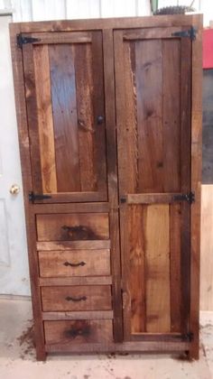 an old wooden armoire sitting in the middle of a room