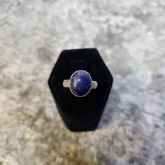 A vintage solid sterling silver ring, with a single deep blue lapis lazuli stone in a bezel setting.  Measurements: The ring is approximately a US size 6.25, the shank is 3/15ths of an inch wide and the stone is 7/16ths of an inch wide by 1/2 an inch high. Condition: Very good; The stone has no cracks, chips or damage beyond surface wear, and the setting has just minor surface wear and a light patina. Age: 1990s to early 2000s. Marks: "925", "Sterling". Weight: 5.3 grams total weight. We specialize in vintage Native American silver jewelry, but we have a large and varied inventory, so please stop by our Etsy shop! https://www.etsy.com/shop/BrantiquesAndMore Blue Lapis Lazuli, Lapis Lazuli Ring, Lapis Lazuli Stone, Please Stop, Blue Lapis, Early 2000s, Rings Statement, Bezel Setting, Deep Blue