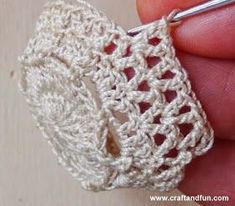 the crochet ring is being worked on by someone using a needle to make it