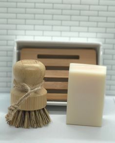 a wooden brush next to a soap bar on a counter