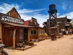 an old western town with wooden buildings and water tower