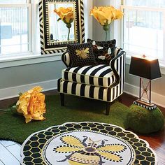 a living room filled with furniture and flowers in front of a mirror on the wall