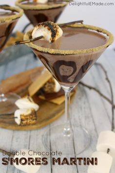 two glasses filled with chocolate and marshmallows