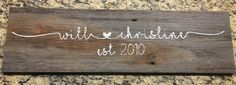 a wooden sign that says with love in white lettering on top of a granite counter