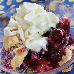 a dessert dish with whipped cream and cherries