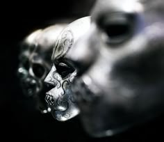 a silver mask with intricate designs on it's face and eyes is seen in this close up photo