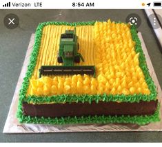 a cake that has been decorated to look like a farm scene with a tractor on it