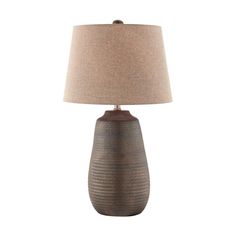 a table lamp with a brown shade on it and a beige linen lampshade