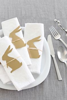 napkins decorated with gold bunny ears on a white plate