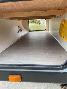 the back end of a truck with its cargo door open and yellow tags on it