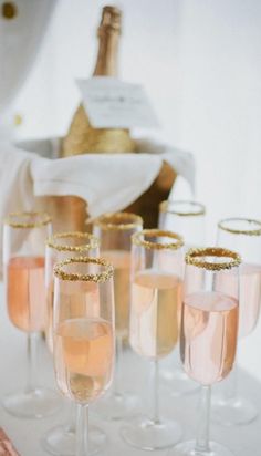 champagne flutes are lined up on a table