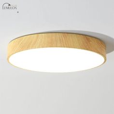 an image of a modern light fixture with wood grain on the bottom and white background