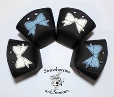 four black and white bows are on the back of small leather pieces that have been stitched together