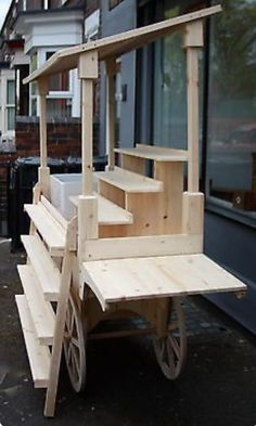 a wooden bench sitting on the side of a road