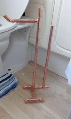 a toilet that has some copper pipes in it